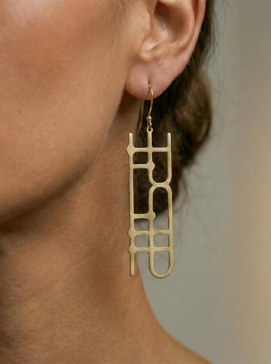 Quantum Earrings worn, brass